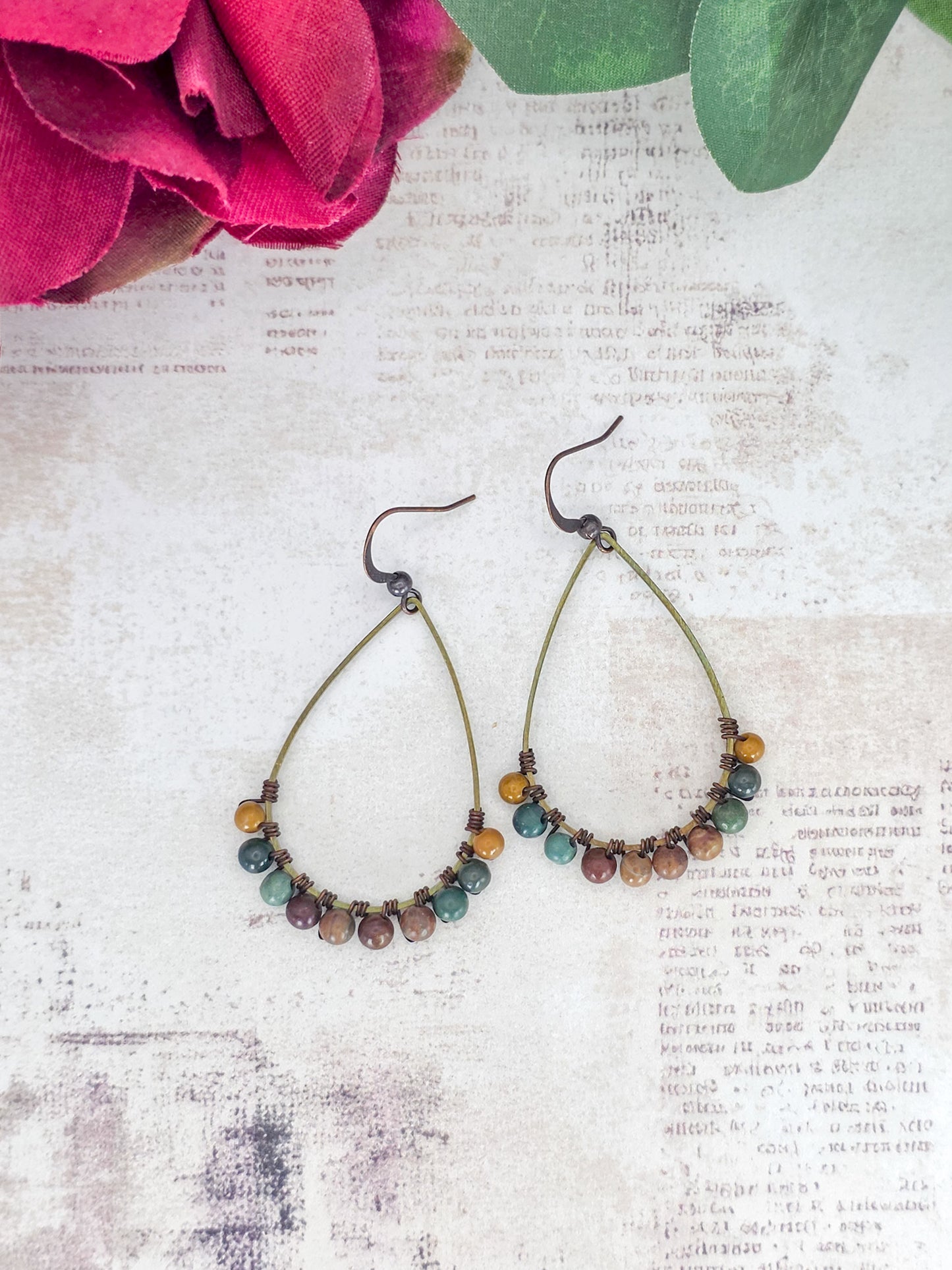 Fancy Jasper gemstone earrings with brass teardrop hoops in earthy green, brown, mustard, and mauve tones.