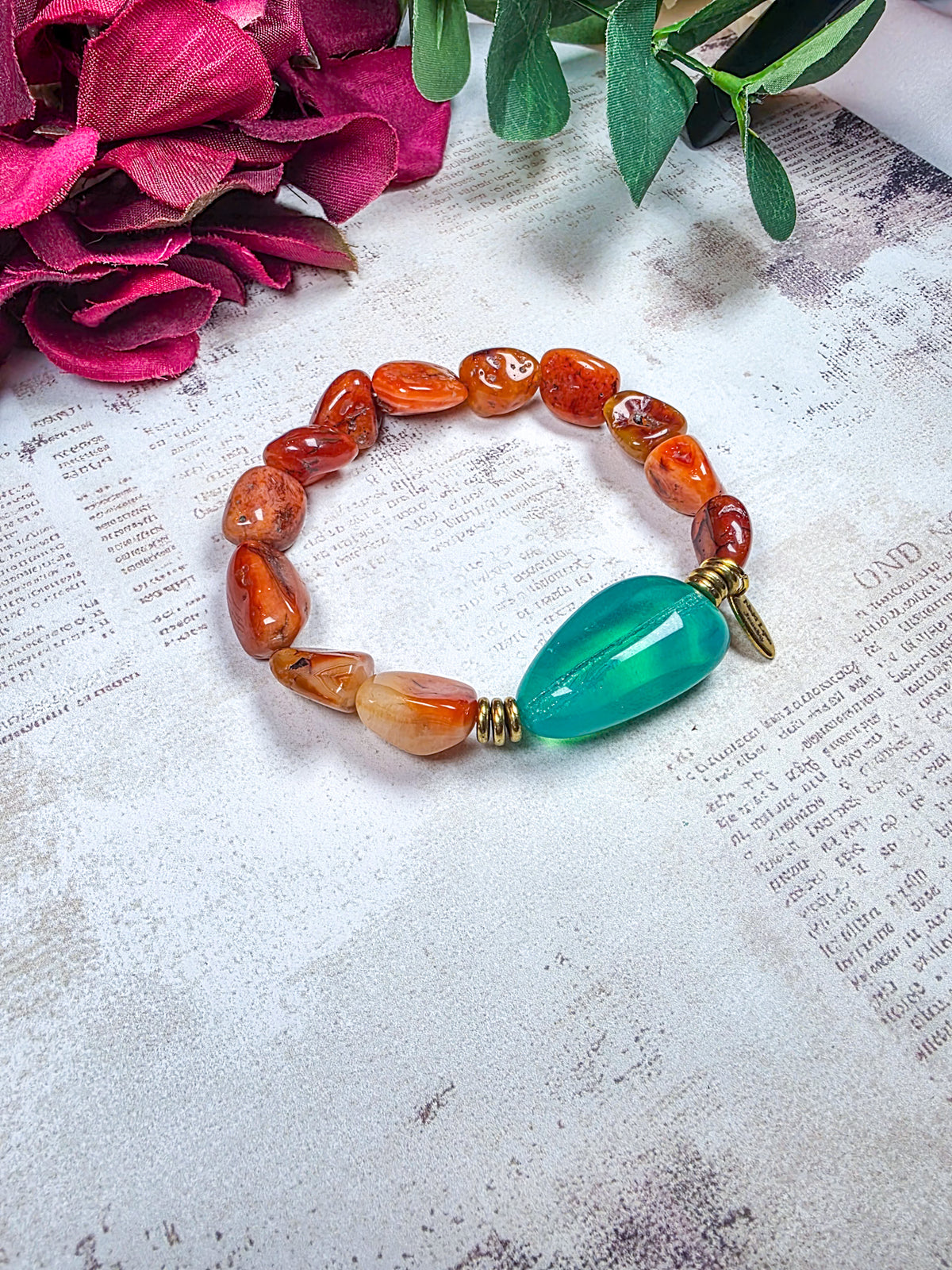 Carnelian beaded bracelet with large aqua Czech glass focal bead and brass accents