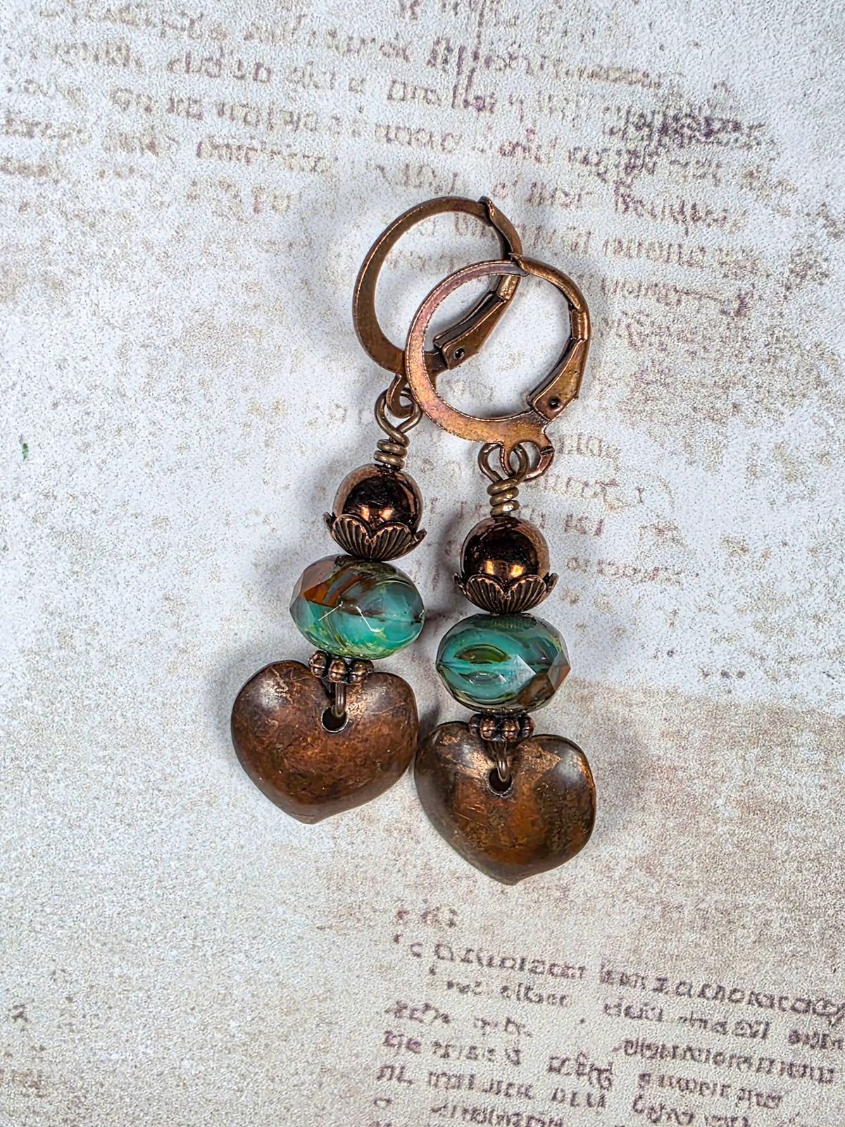 Aged copper heart earrings with turquoise brown Czech glass beads and antiqued copper leverback ear wires