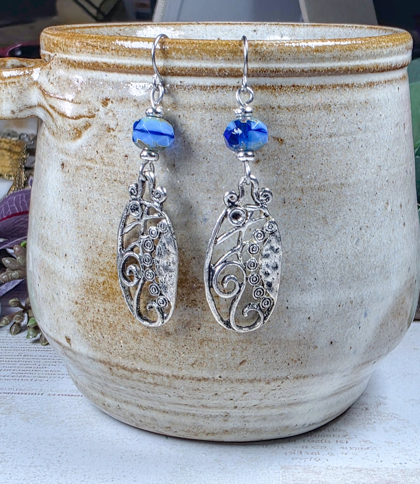 Blue Czech glass dangle earrings with silver scrollwork and stainless steel ear wires