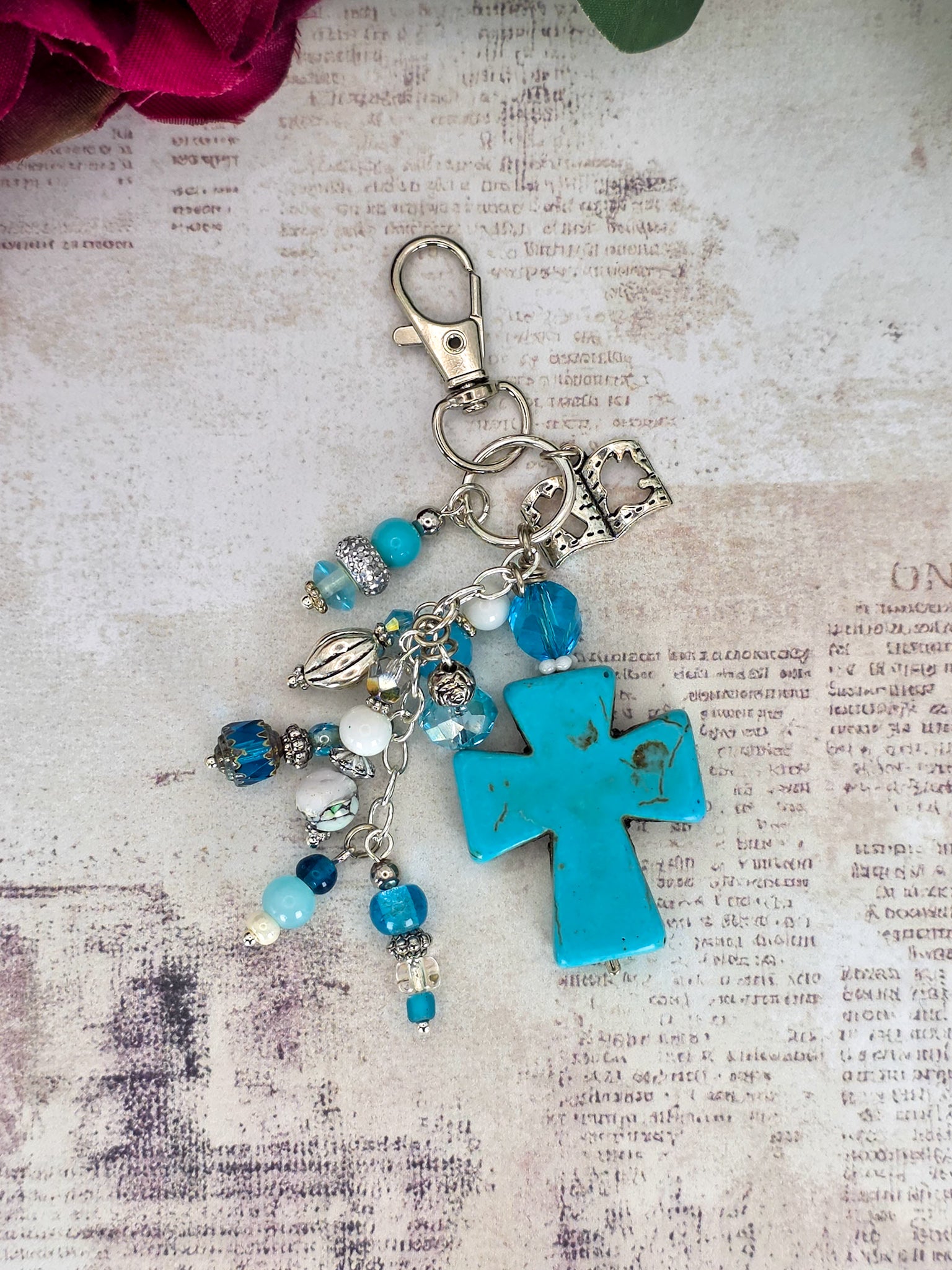 Handcrafted turquoise howlite cross purse charm with blue glass beads, Bible charm, and silver-tone keychain clip.