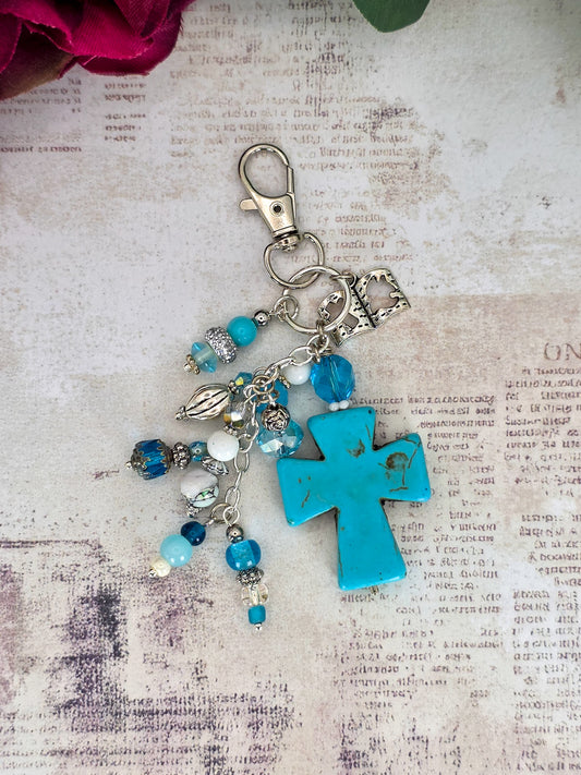 Handcrafted turquoise howlite cross purse charm with blue glass beads, Bible charm, and silver-tone keychain clip.
