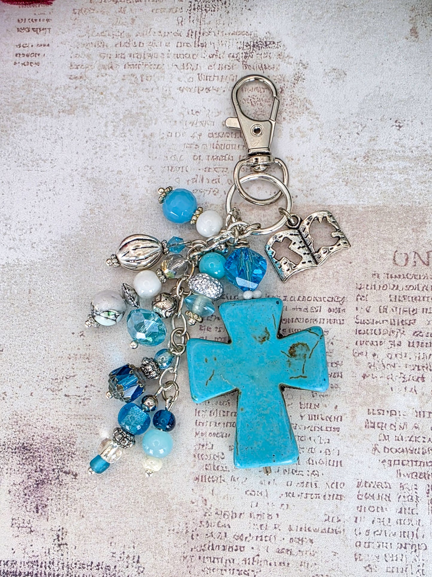 Handcrafted turquoise howlite cross purse charm with blue glass beads, Bible charm, and silver-tone keychain clip.