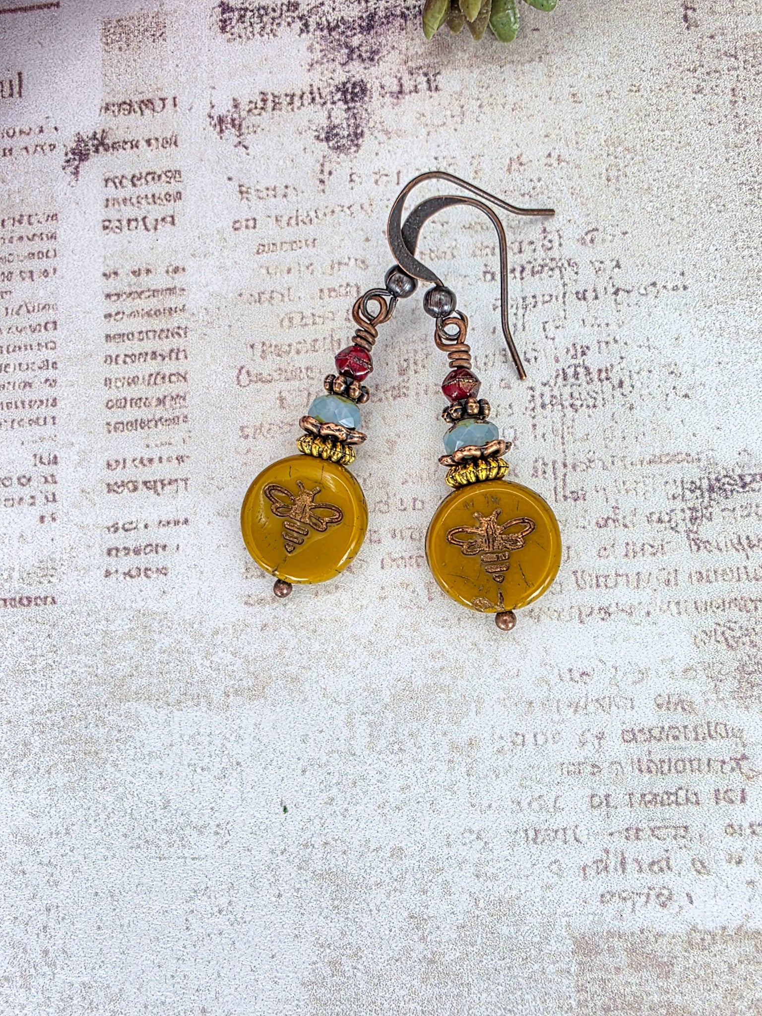 Mustard Picasso Czech glass bee earrings with copper ear wires and brass accents.