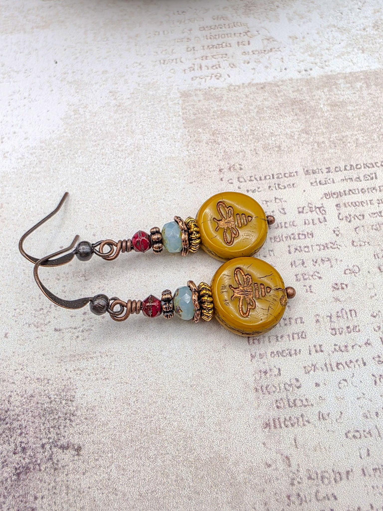 Mustard Picasso Czech glass bee earrings with copper ear wires and brass accents.