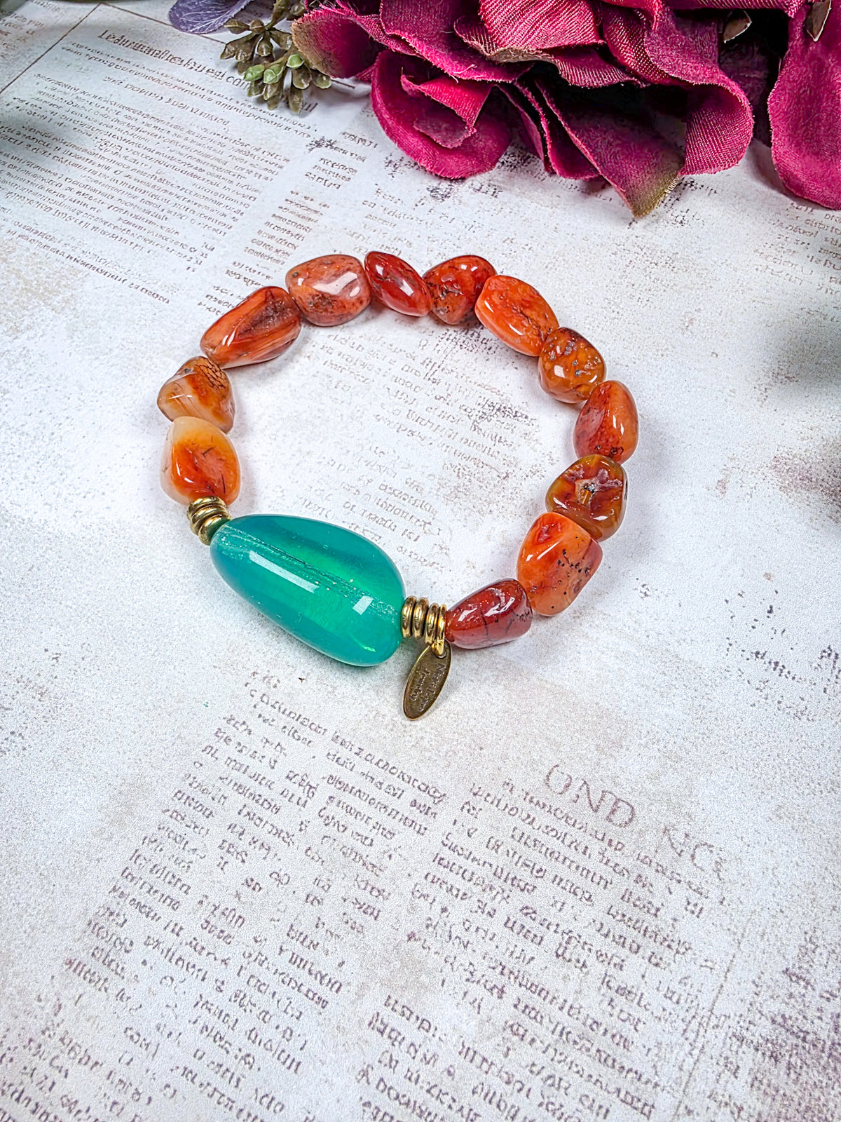 Carnelian beaded bracelet with large aqua Czech glass focal bead and brass accents