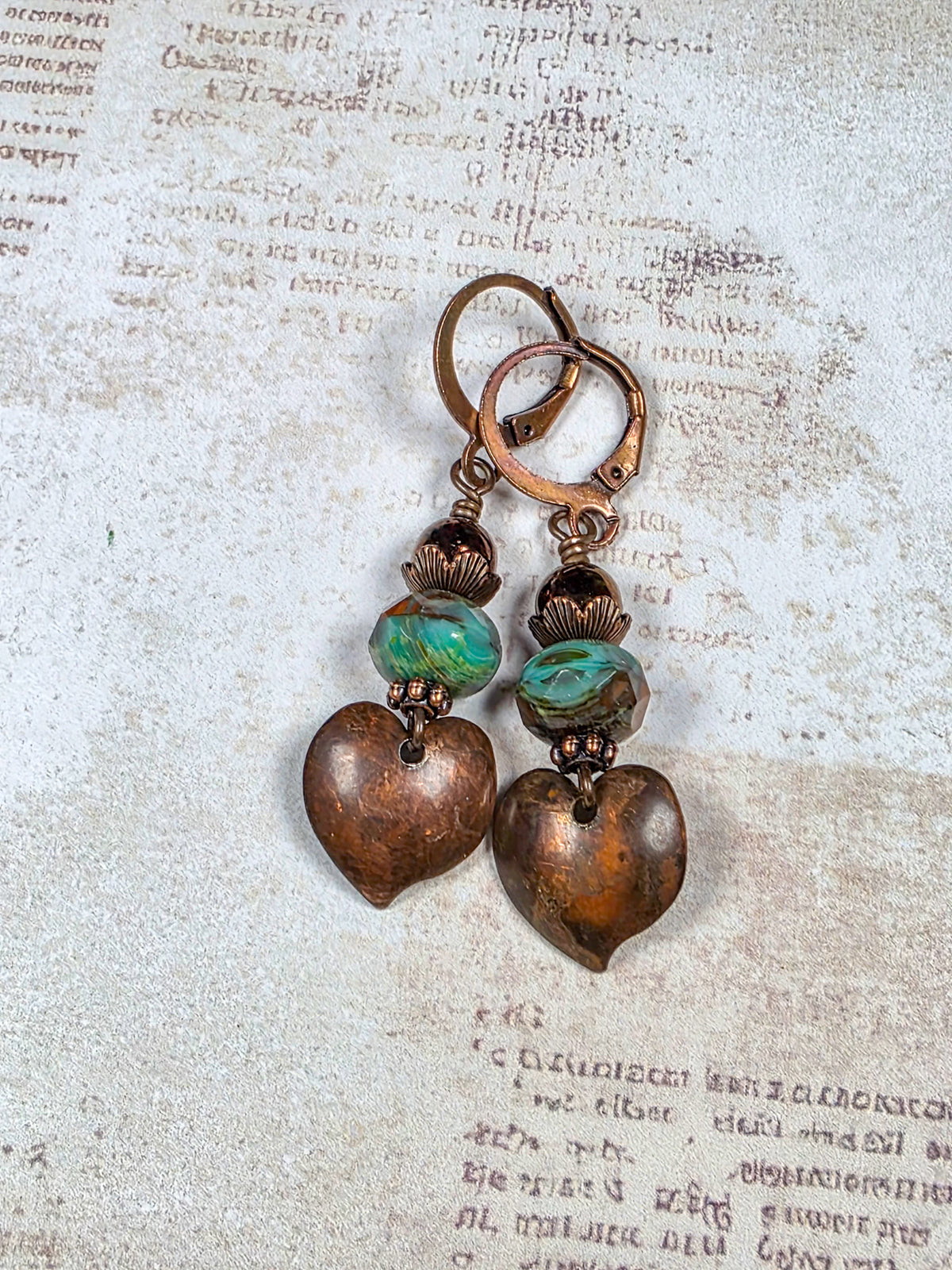 Aged copper heart earrings with turquoise brown Czech glass beads and antiqued copper leverback ear wires