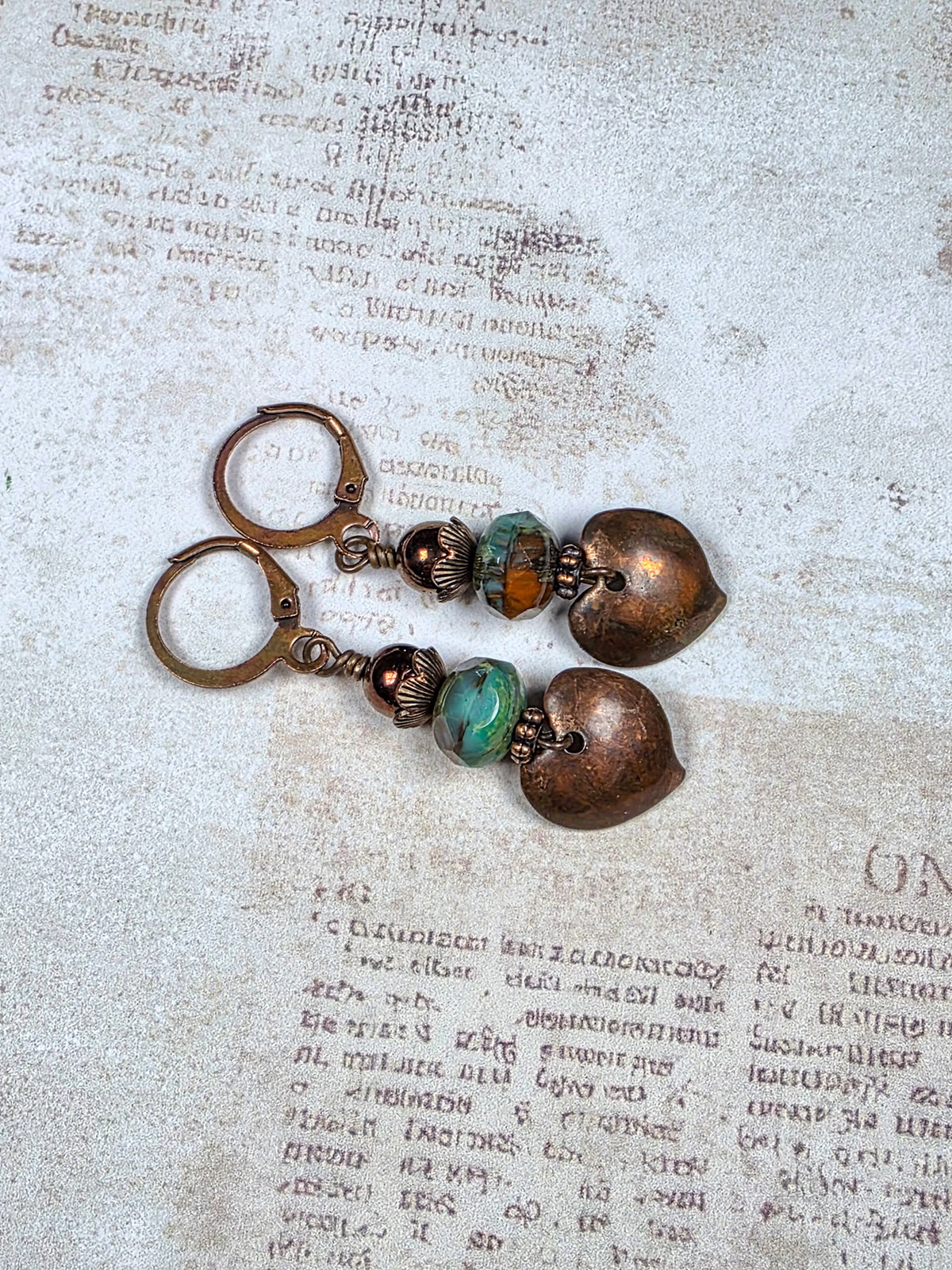 Aged copper heart earrings with turquoise brown Czech glass beads and antiqued copper leverback ear wires