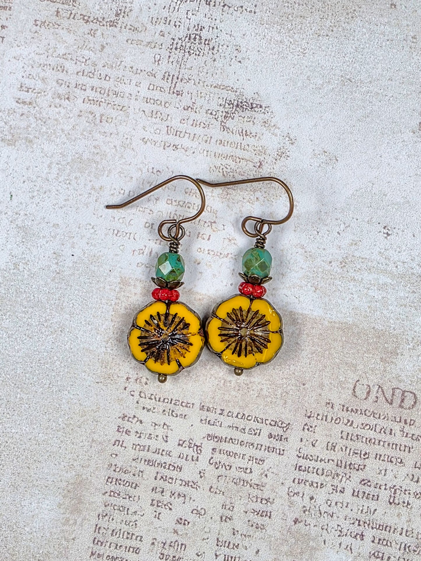 Mustard yellow Czech glass flower earrings with green and red beads and antiqued brass accents