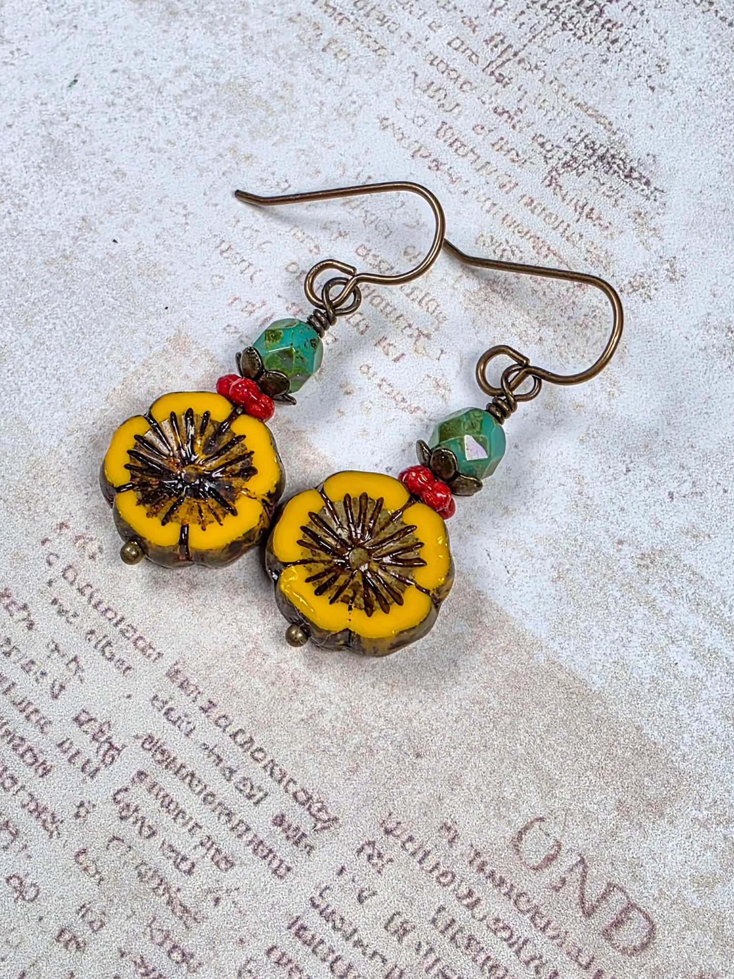 Mustard yellow Czech glass flower earrings with green and red beads and antiqued brass accents