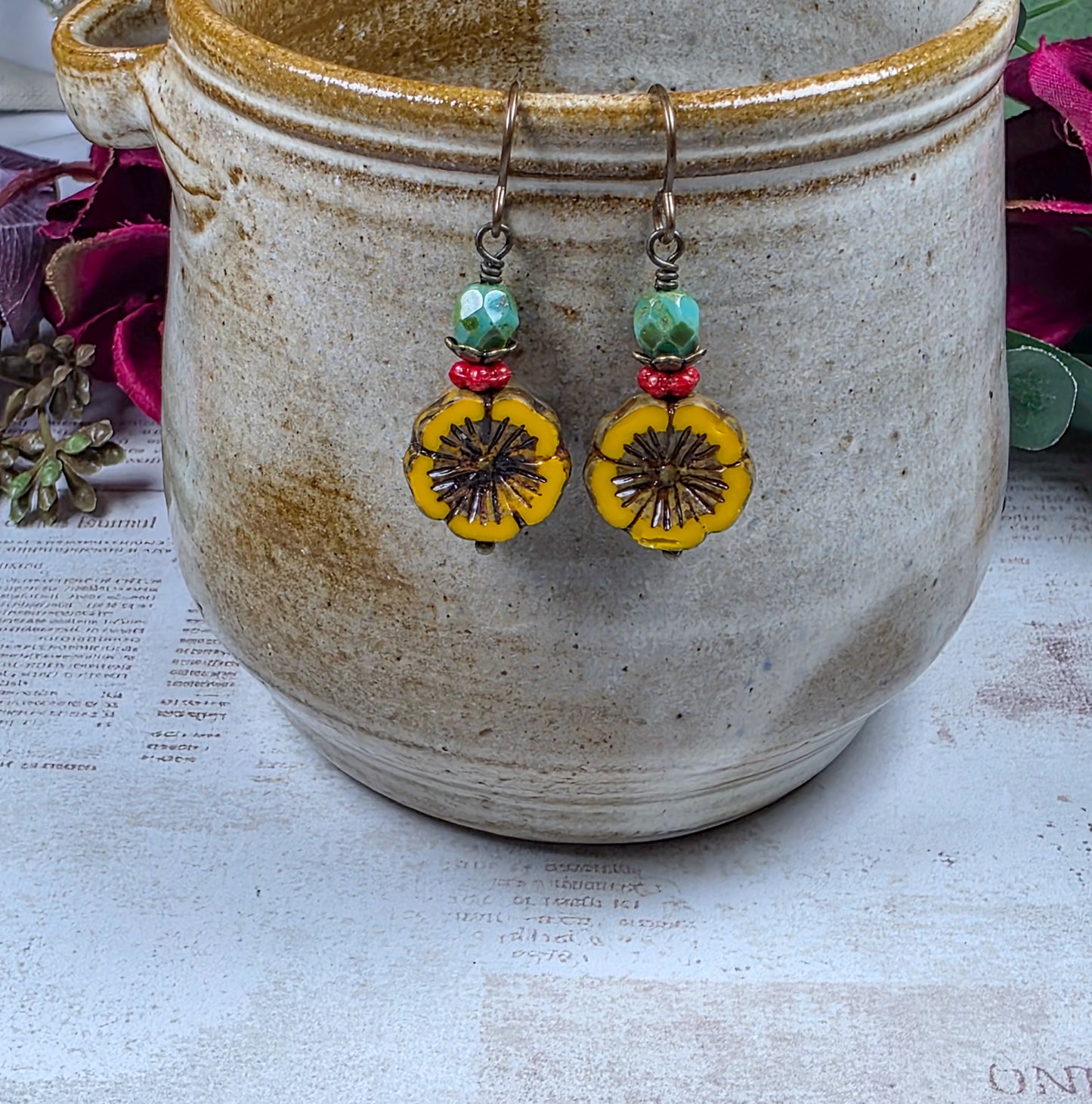 Mustard yellow Czech glass flower earrings with green and red beads and antiqued brass accents