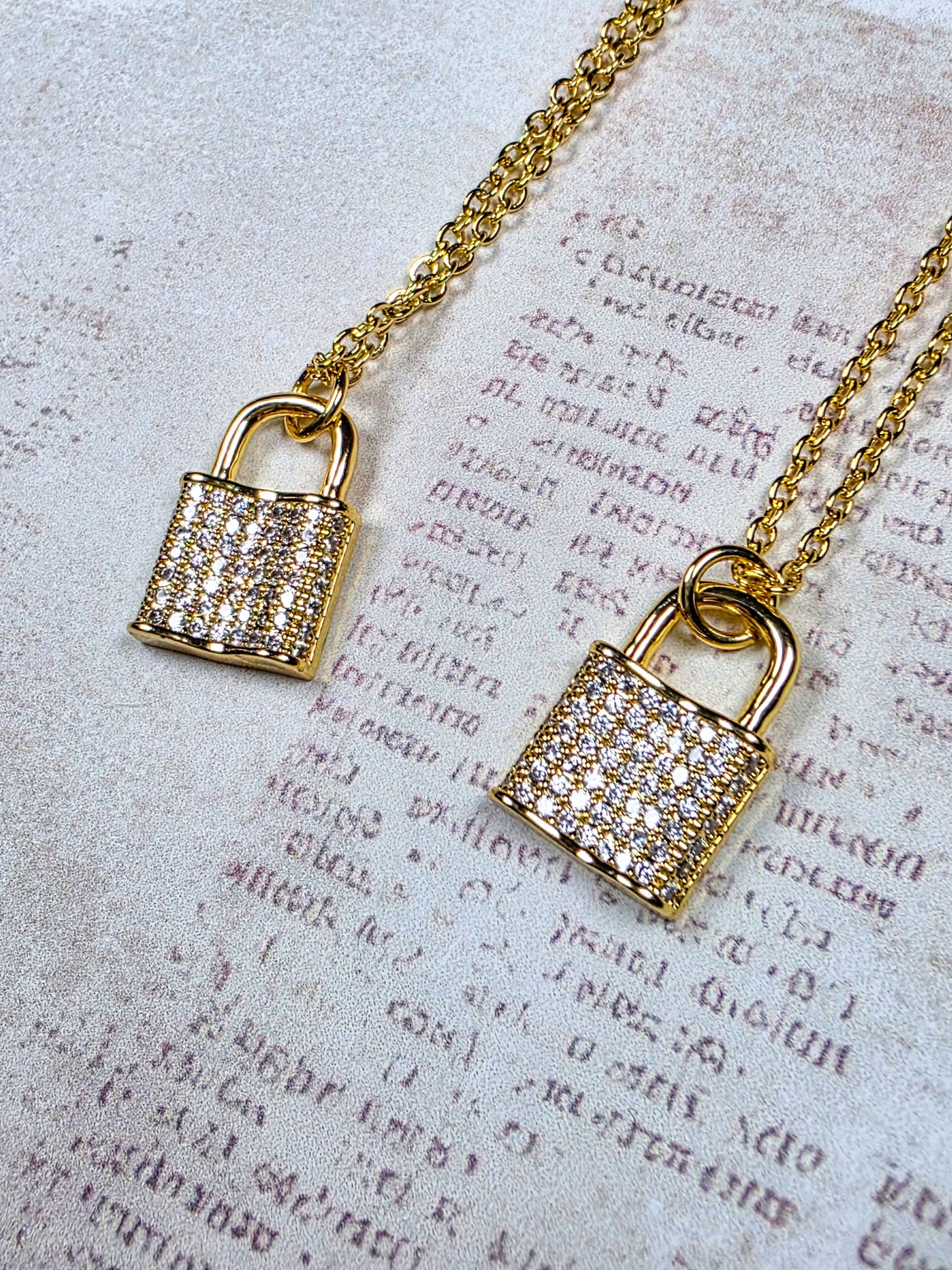 Gold cubic zirconia pavé lock pendant necklace on 16-inch chain