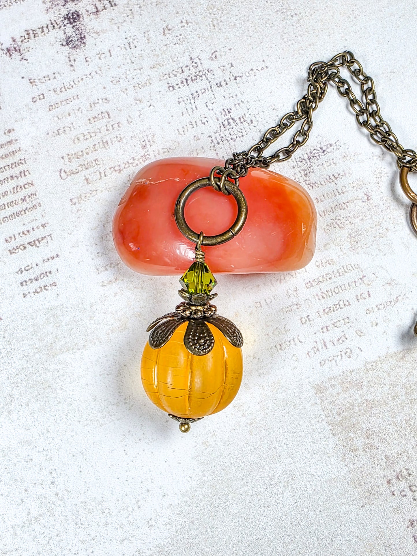 Long orange lucite pendant necklace with Swarovski crystal and antiqued brass accents