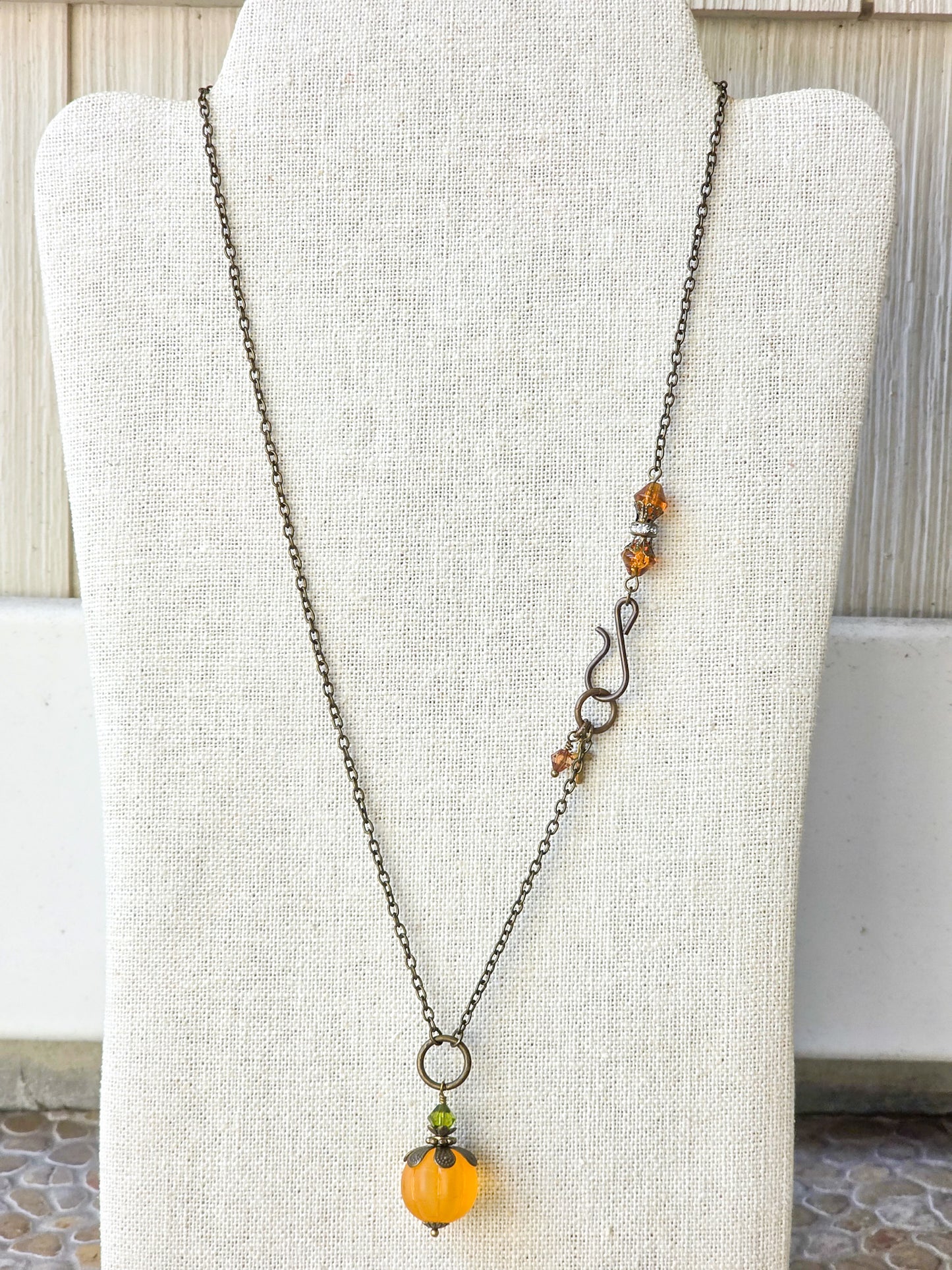 Long orange lucite pendant necklace with Swarovski crystal and antiqued brass accents