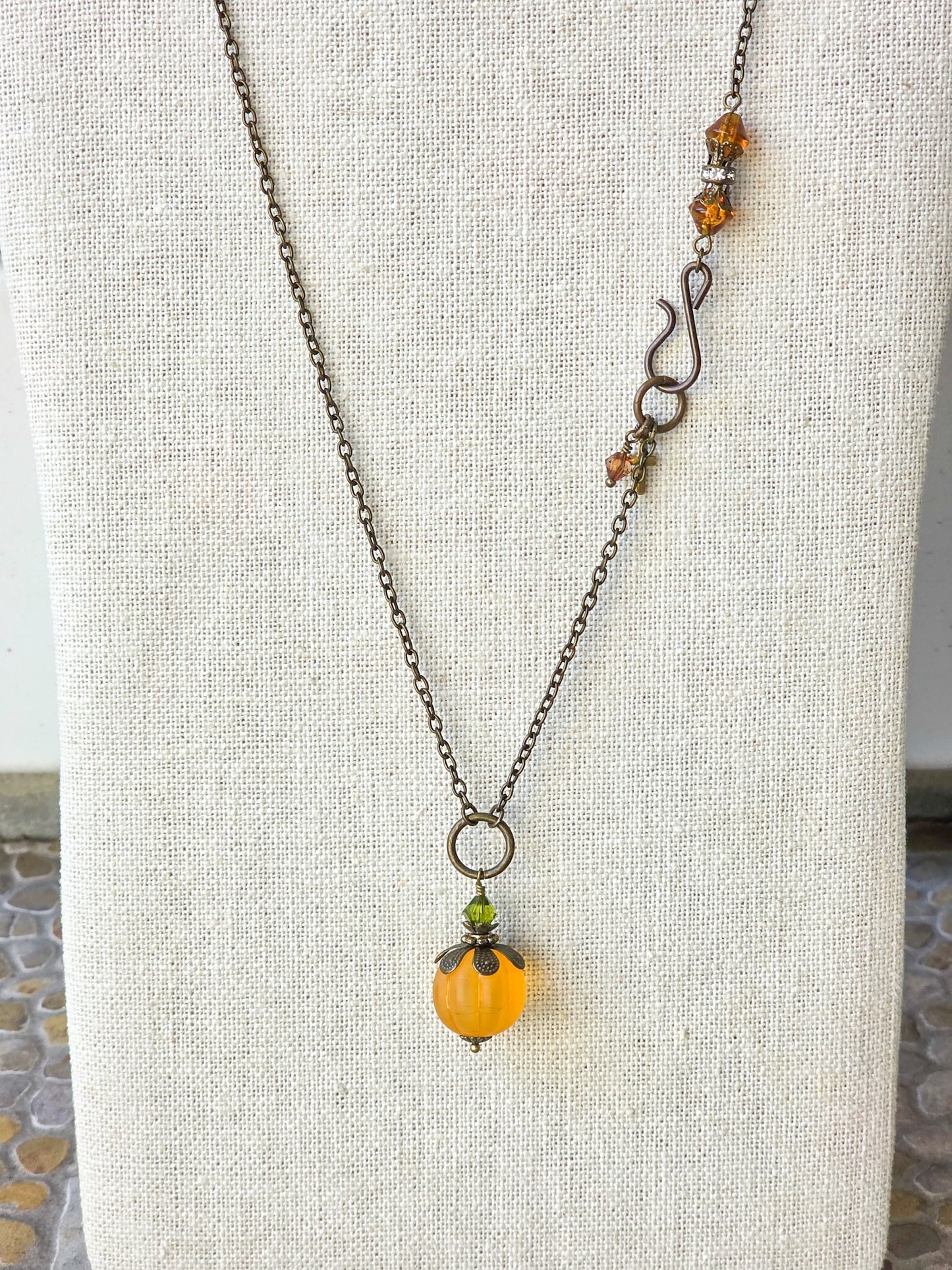 Long orange lucite pendant necklace with Swarovski crystal and antiqued brass accents