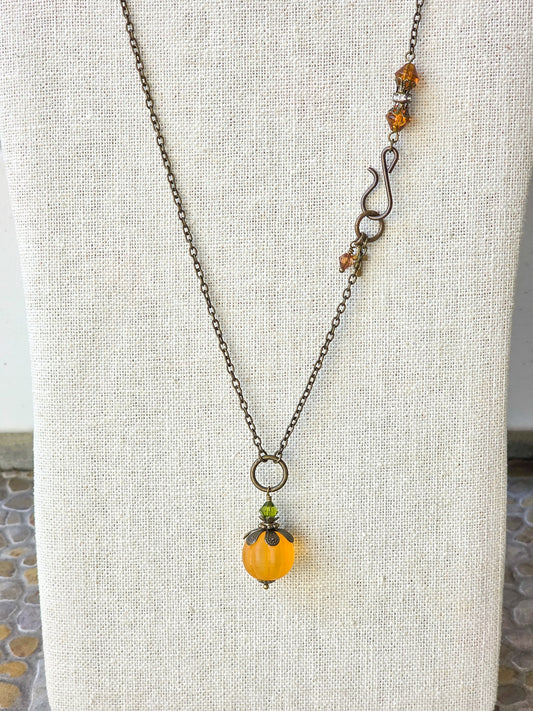 Long orange lucite pendant necklace with Swarovski crystal and antiqued brass accents