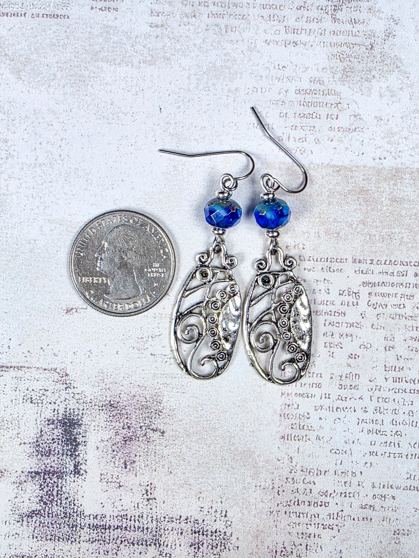 Blue Czech glass dangle earrings with silver scrollwork and stainless steel ear wires