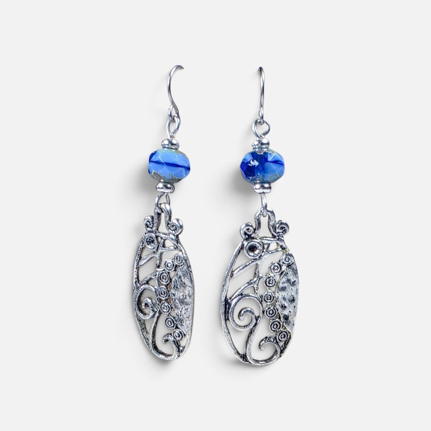 Blue Czech glass dangle earrings with silver scrollwork and stainless steel ear wires