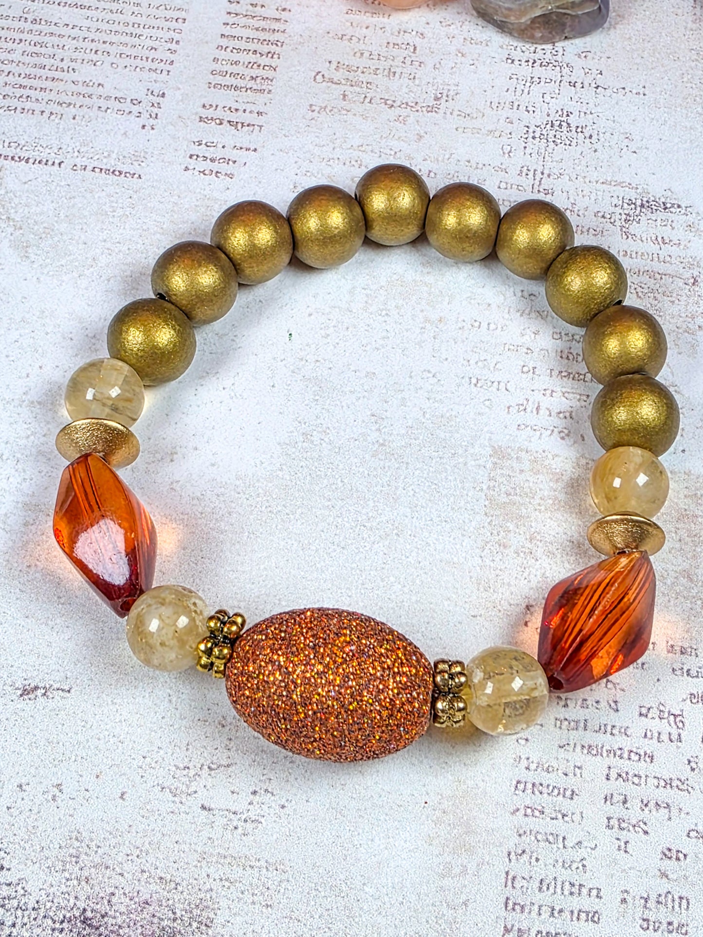 Earthy terracotta beaded stretch bracelet with burnt orange acrylic and bronze-gold wood beads