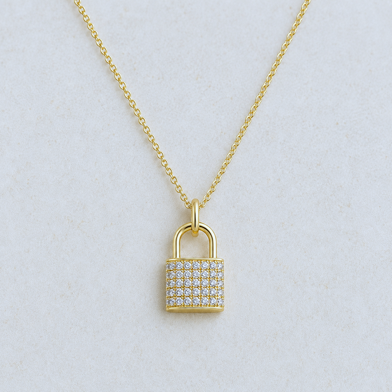 Gold cubic zirconia pavé lock pendant necklace on 16-inch chain